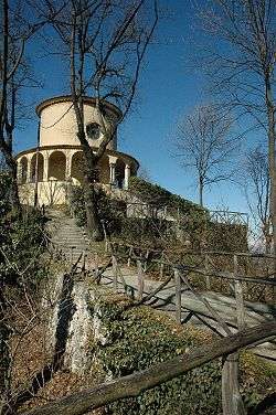 A circular building on top of a mountain.