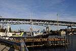 A steel bridge with two decks crossing high above a body of water