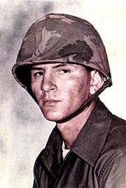 A color image of Gonzalez wearing his combat uniform with Kevlar helmet.