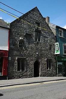 Three-story stone building with arched doorway