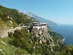 A large building complex and church built on a cliffside.