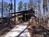 Visitor center surrounded by pine trees.