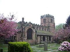 A Gothic church with a battlemented clerestory and west tower