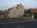 Small stone building with crosses on the roof.