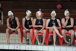 five women in bathing suits sitting on chairs