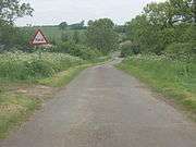 The road crosses a ford just north of Graby.  This is an idylic view of the Lincolnshire countryside with the hedgerows and trees in full summer splendour and the Keck in bloom along the road verges.