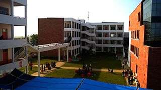 Modern red-brick buildings with white exterior balconies