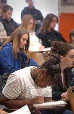 Students taking notes in a classroom