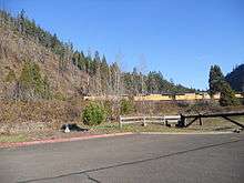 A locomotive on the Union Pacific Railroad passing by Westfir