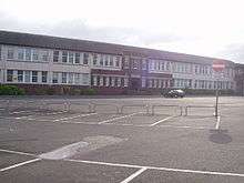 Partial view of two storey school building and its main entrance