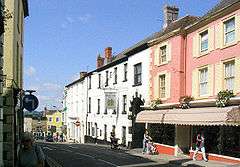 Street scene with white and pink buildings.