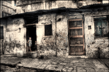 A child stands in a doorway in this HDR image taken in India.