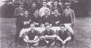 Players and staff pose for a photograph