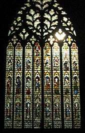 A very large window of eight lights rising to elaborate tracery in the form of a sacred heart