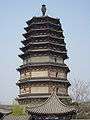 A wide, octagonal pagoda. It has four tall, functional floors made of brick, and an additional five, short, purely decorative floors made of wood. Each floor is separated by an eave, and the top five floor's eaves look as if they were simply stacked right on top of one another.