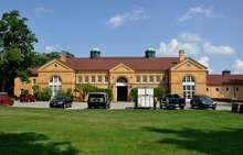 A large classical two-story tan-brick building